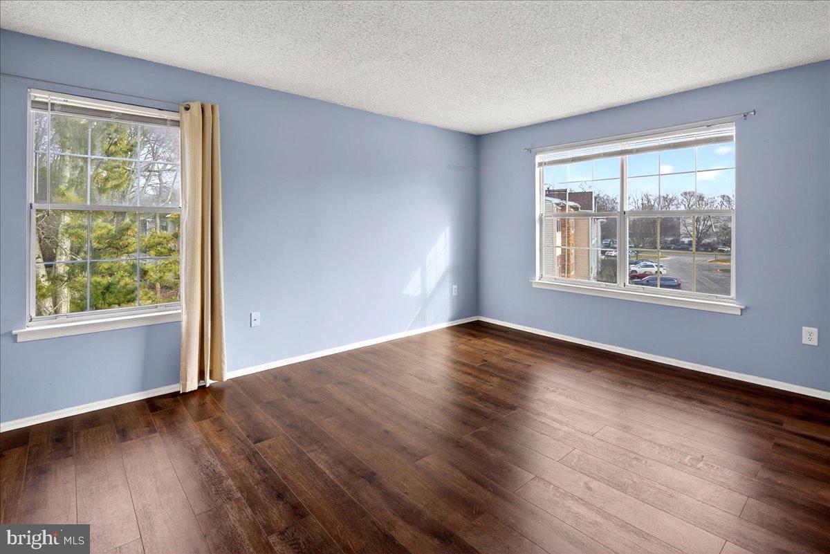 28 Holly Court Hamilton, NJ 08619 - Photo 15 of 29 a view of an empty room with wooden floor and a window