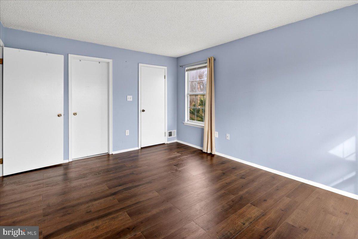 28 Holly Court Hamilton, NJ 08619 - Photo 16 of 29 a view of an empty room with wooden floor and a window