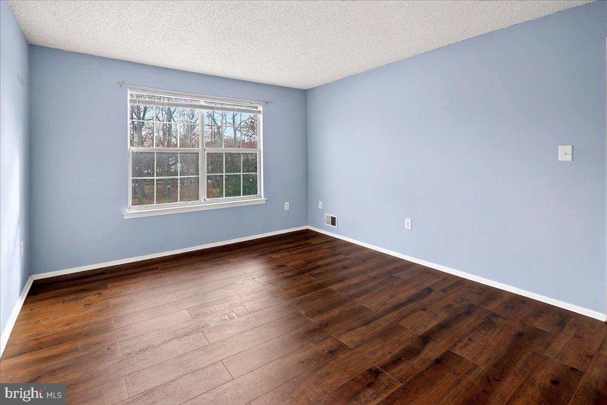 28 Holly Court Hamilton, NJ 08619 - Photo 17 of 29 wooden floor in an empty room with a window