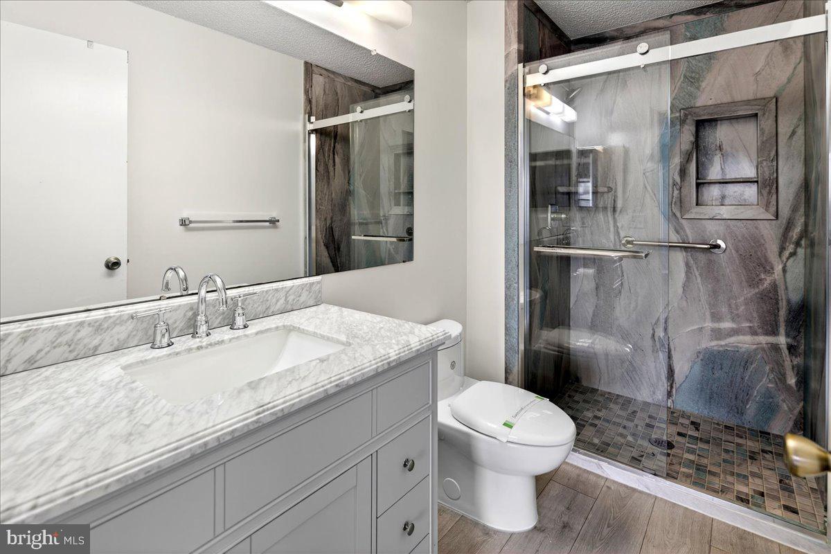 28 Holly Court Hamilton, NJ 08619 - Photo 19 of 29 a bathroom with a granite countertop sink toilet and shower