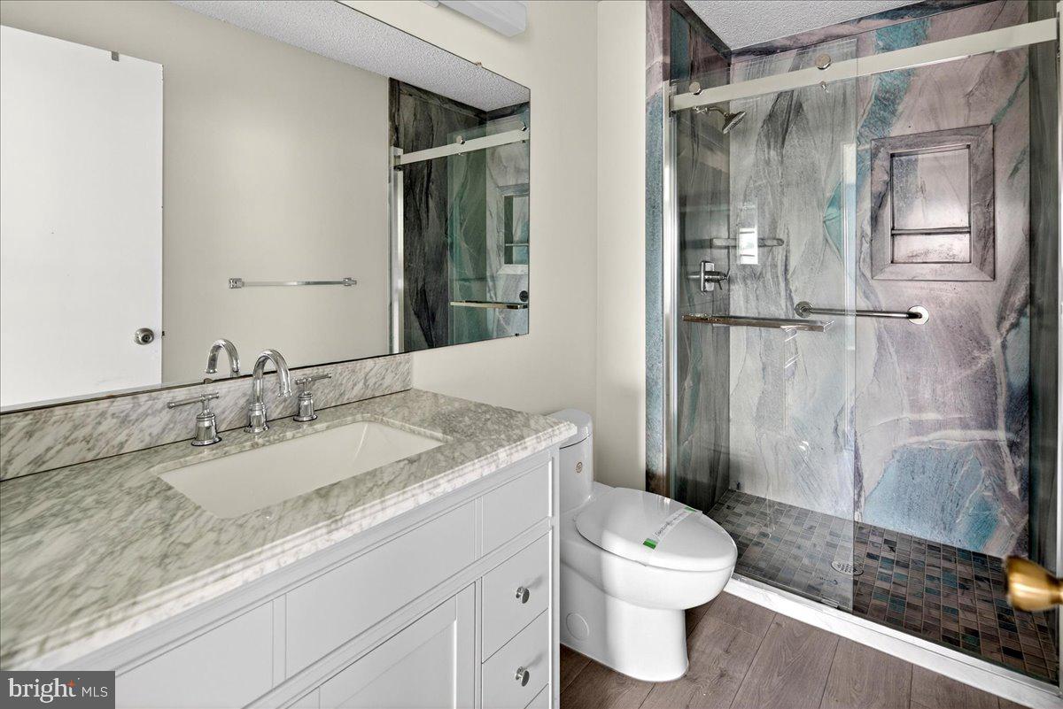 28 Holly Court Hamilton, NJ 08619 - Photo 20 of 29 a bathroom with a granite countertop sink toilet and shower