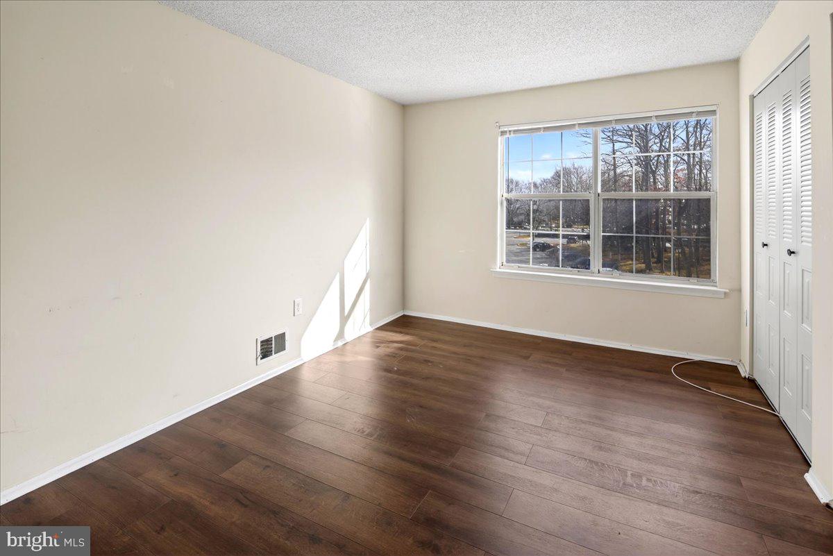 28 Holly Court Hamilton, NJ 08619 - Photo 21 of 29 an empty room with wooden floor and windows
