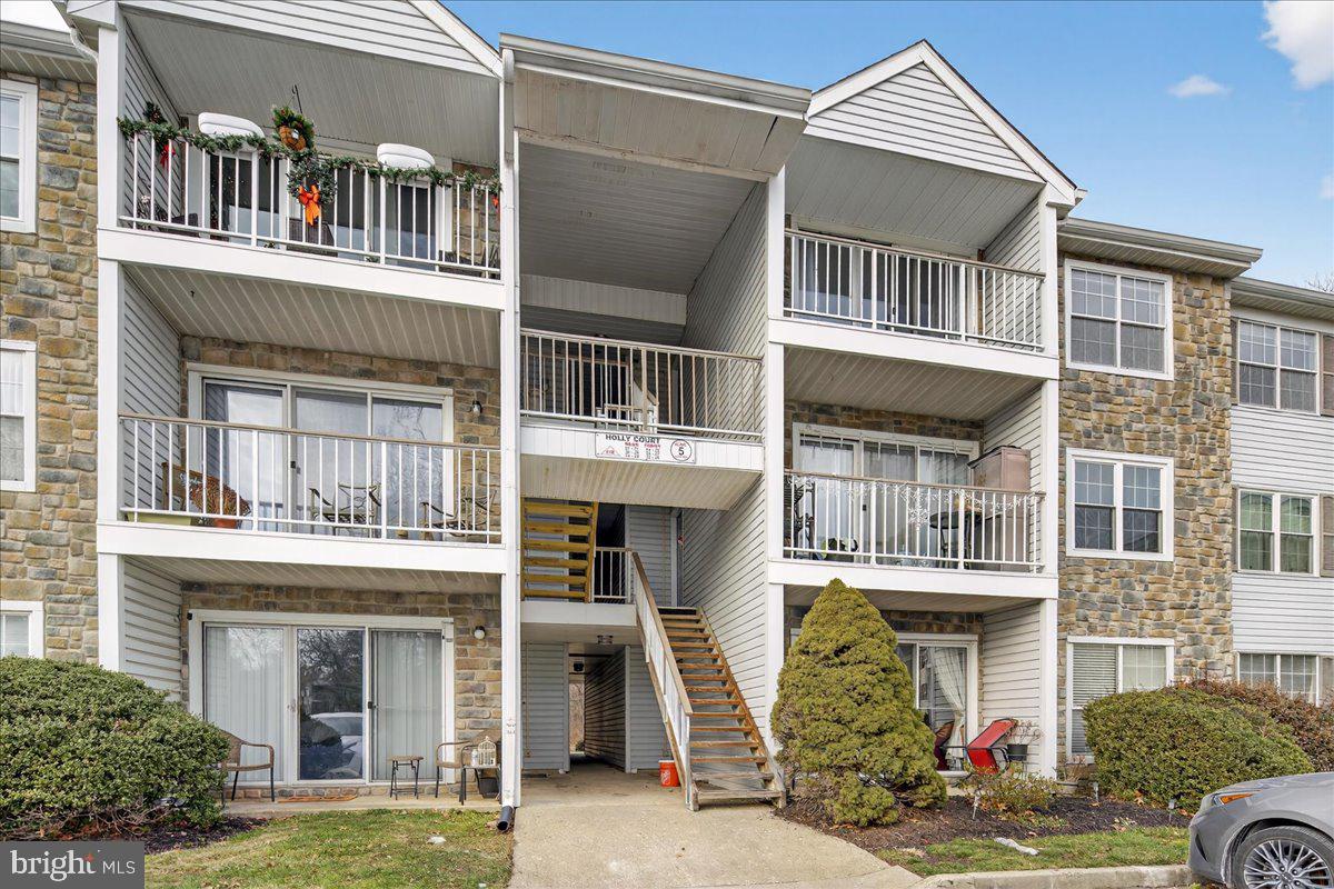28 Holly Court Hamilton, NJ 08619 - Photo 3 of 29 a front view of a residential apartment building with a yard