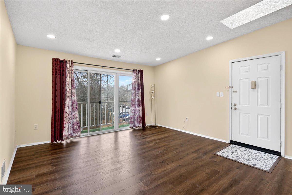 28 Holly Court Hamilton, NJ 08619 - Photo 8 of 29 a view of an empty room with wooden floor and a window