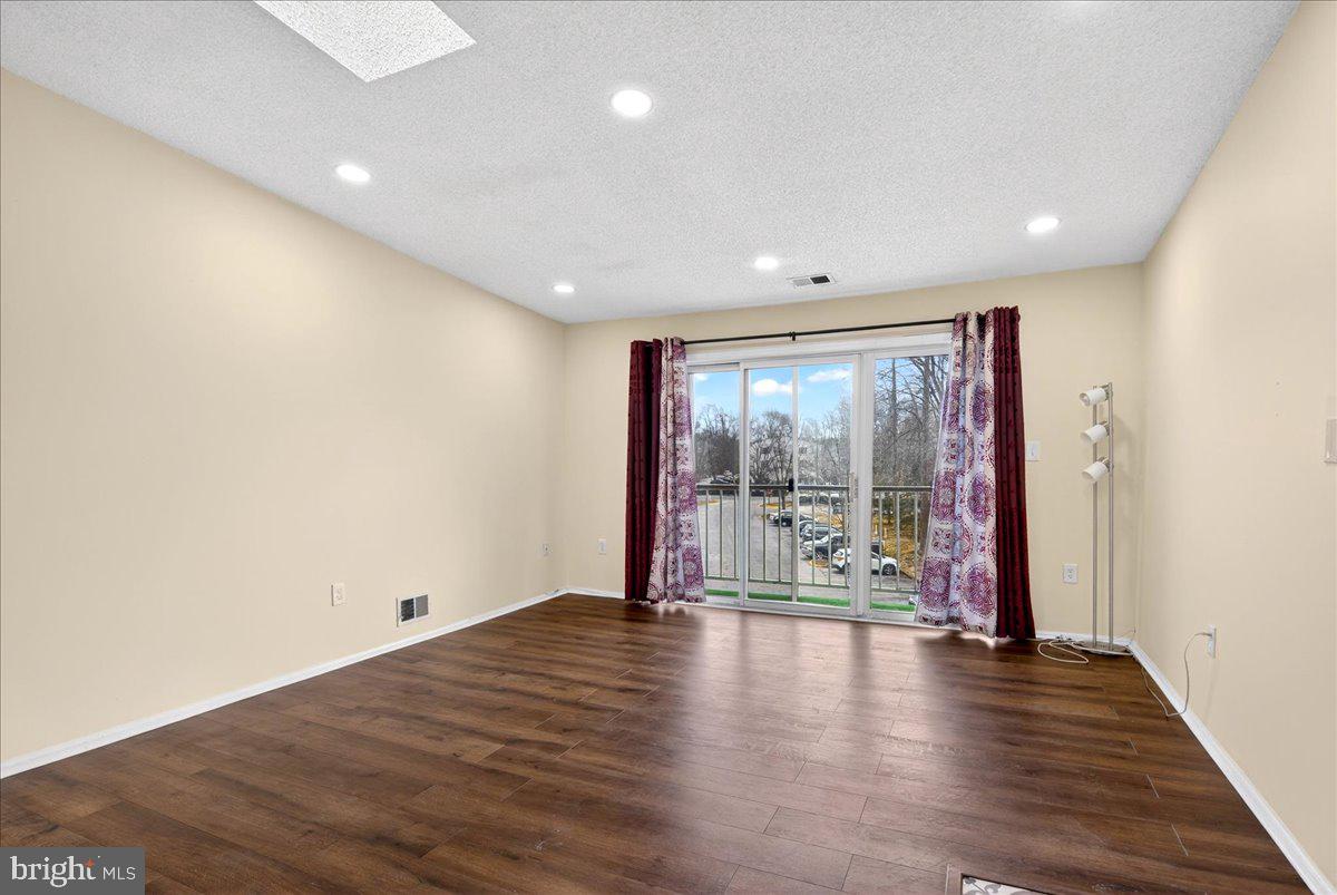 28 Holly Court Hamilton, NJ 08619 - Photo 9 of 29 an empty room with wooden floor and walls