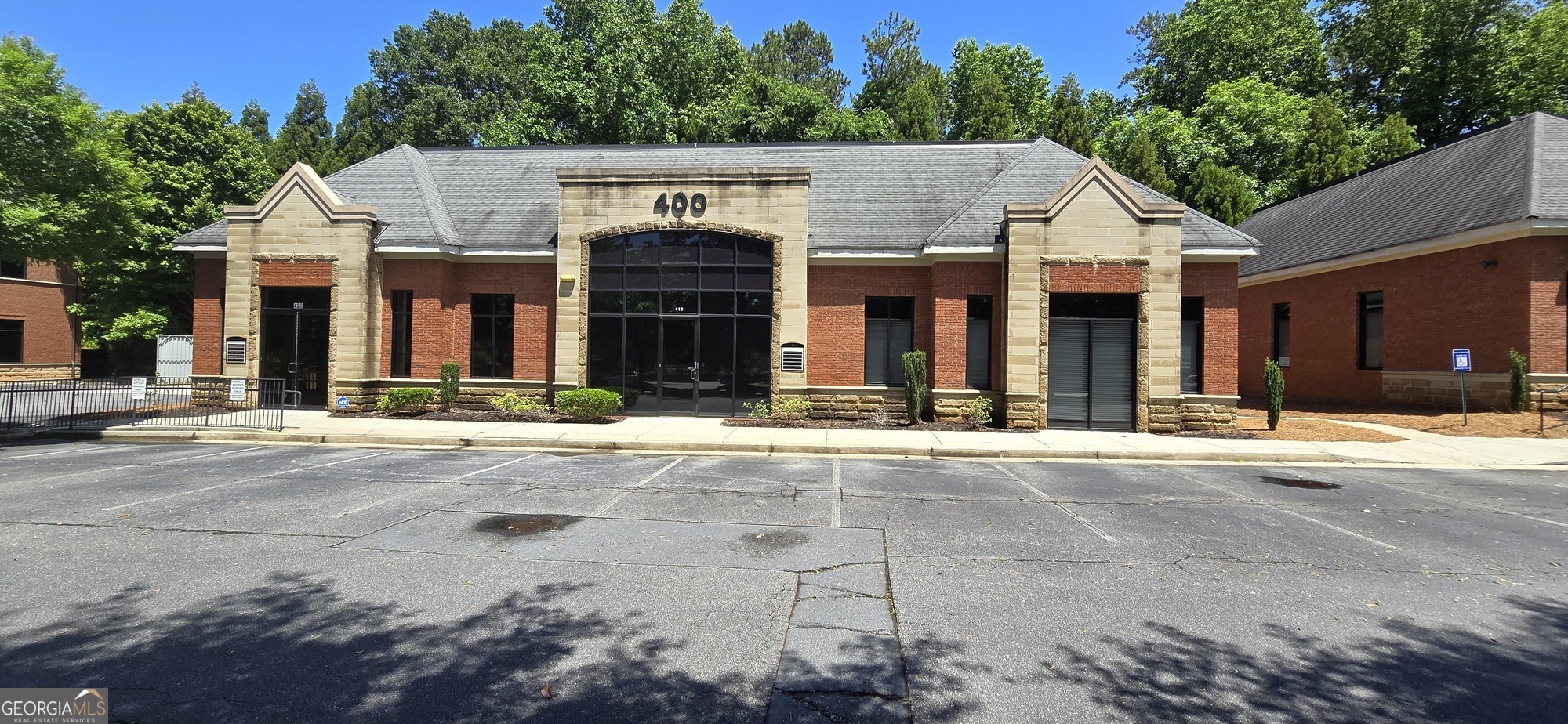 10475 Medlock Bridge Road, Unit 900 Duluth, GA 30097 - Photo 8 of 13 a view of a house with brick walls and plants