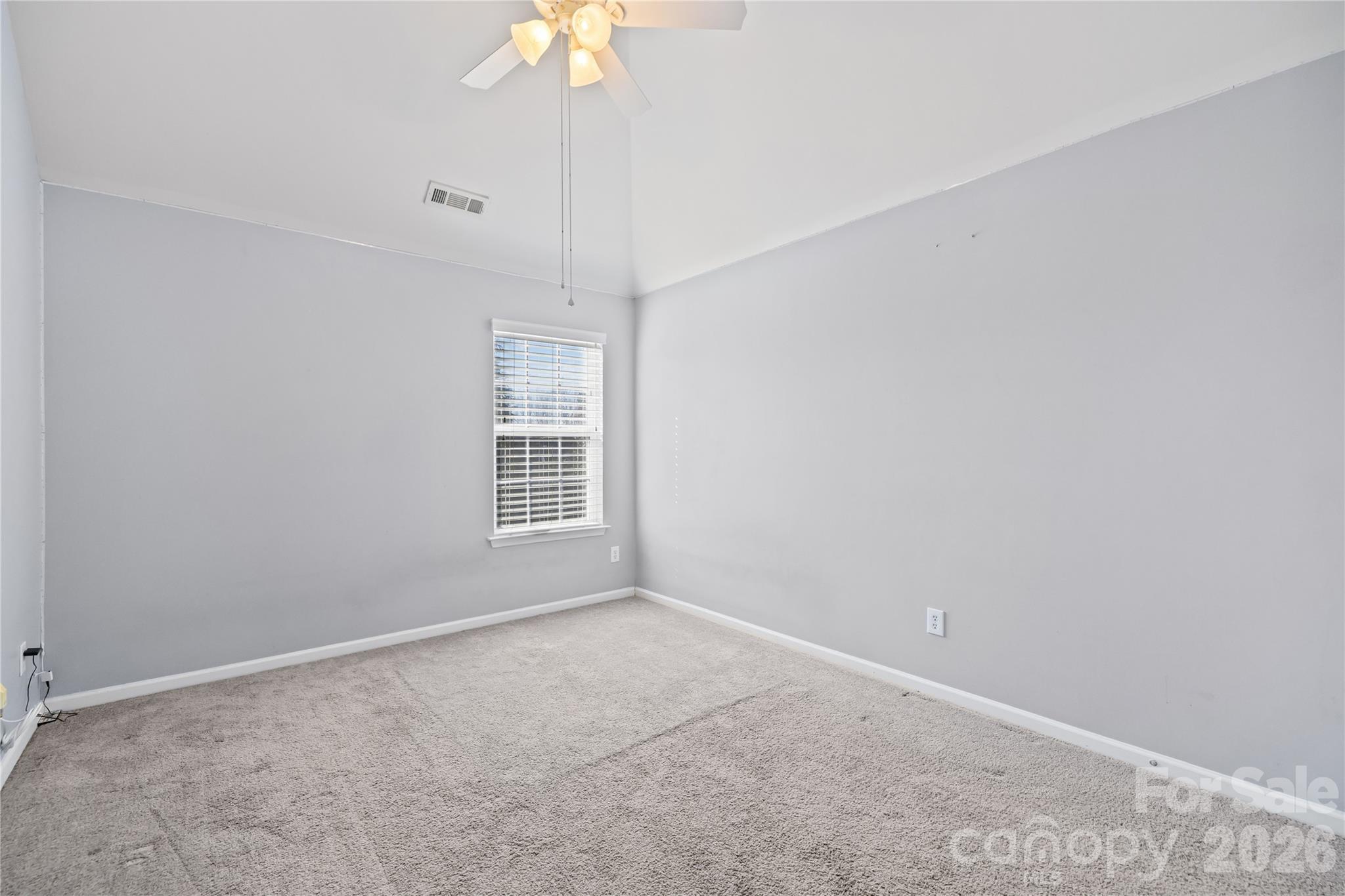 4017 Brookchase Boulevard Fort Mill, SC 29707 - Photo 29 of 43 an empty room with a chandelier fan and windows