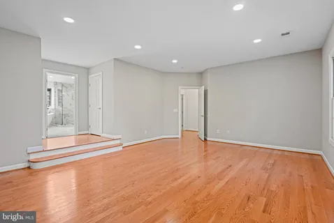 a white bath tub sitting next to a shower
