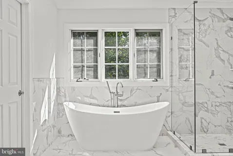 a spacious bathroom with a sink and a mirror