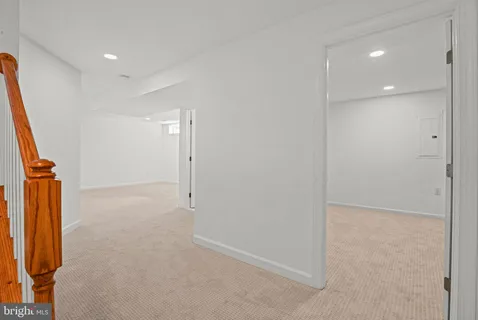 a picture of floor with a white wall and a painting