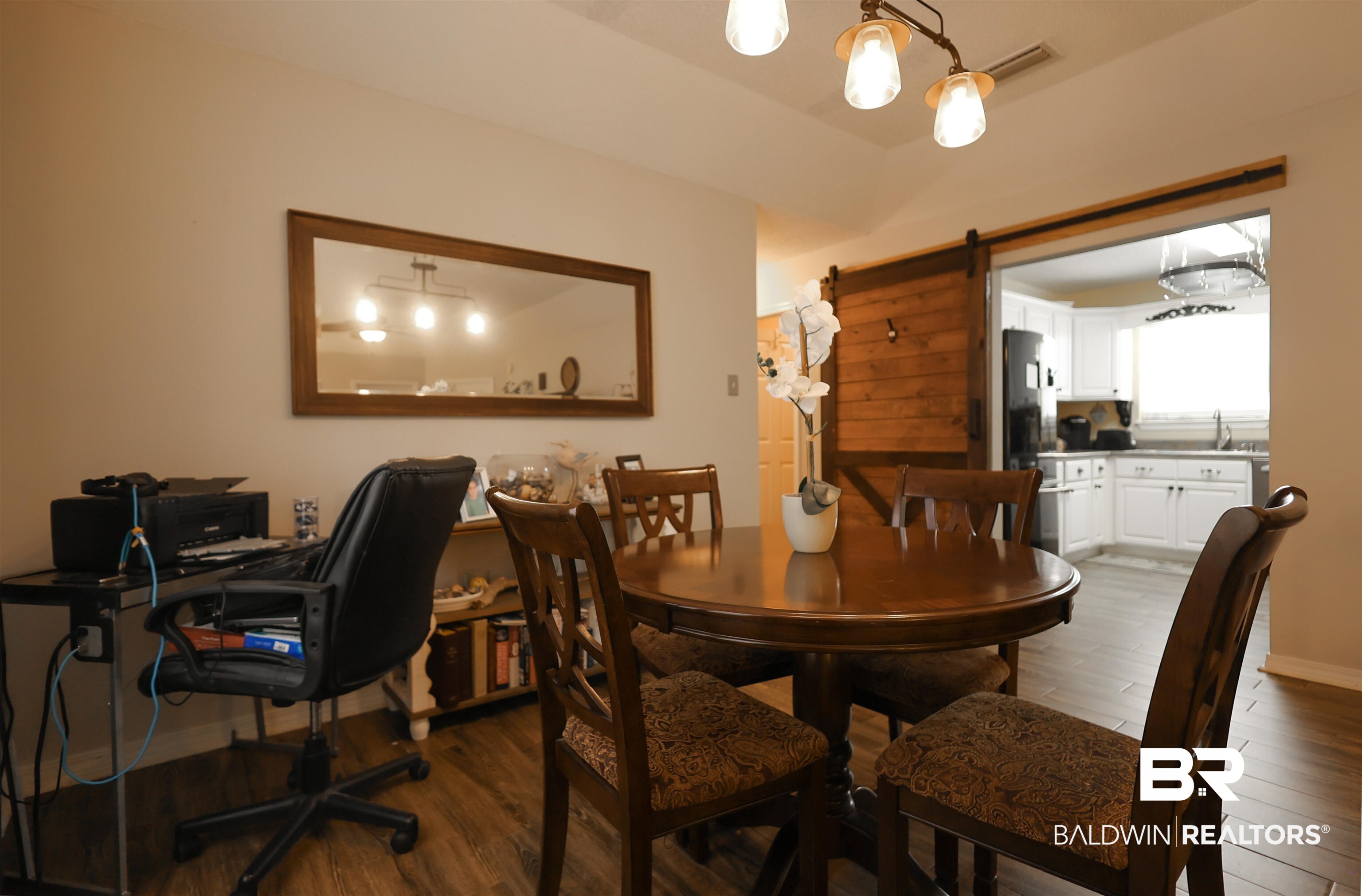 7790 Audubon Drive Foley, AL 36535 - Photo 12 of 39 Interior dining area featuring wood-finish flooring and a decorative chandelier
