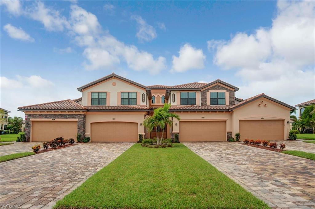 9126 Napoli Court, Unit 101 Naples, FL 34113 - Photo 2 of 32 a front view of a house with a garden and yard