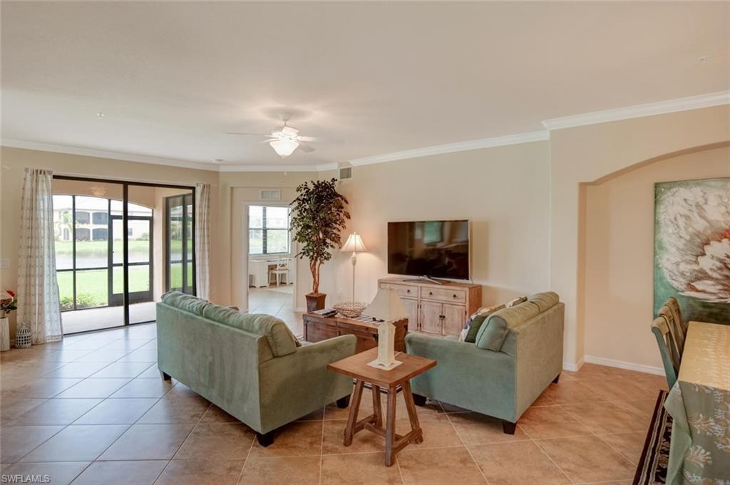 9126 Napoli Court, Unit 101 Naples, FL 34113 - Photo 5 of 32 a living room with furniture and a flat screen tv