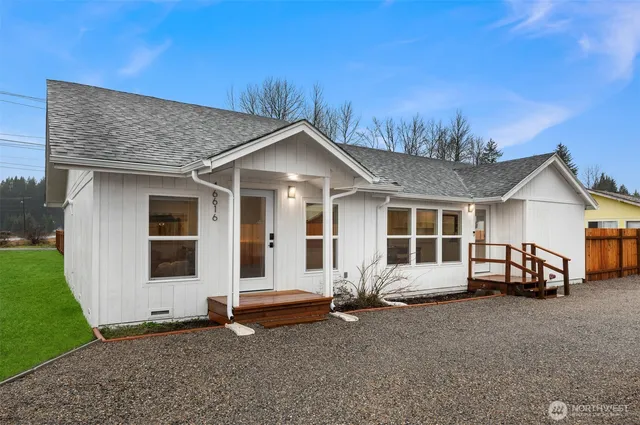 a view of a house with a yard and sitting area