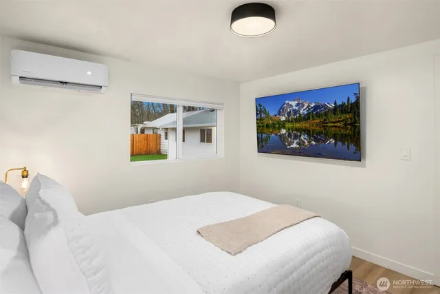 a bedroom with a bed and wall painting