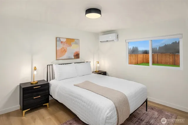 a bedroom with a bed and a painting on the wall