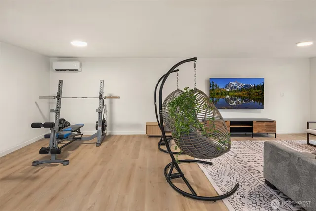a living room with furniture a rug and a wooden floor