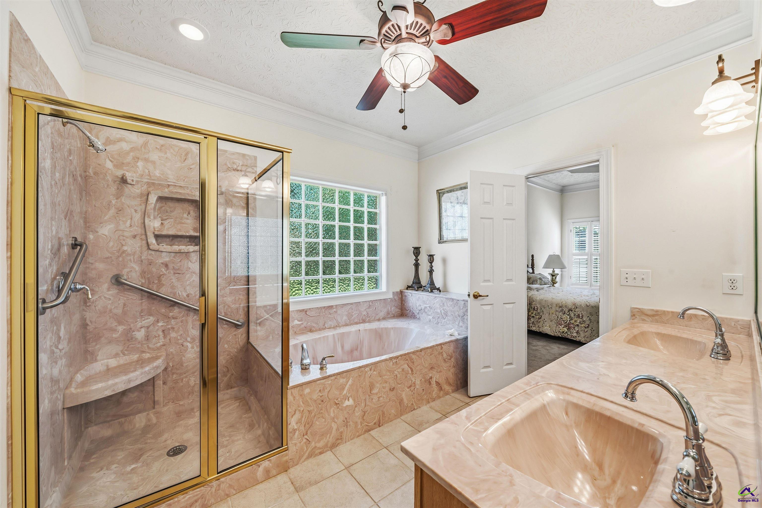206 North Hampton Place Perry, GA 31069 - Photo 14 of 20 a spacious bedroom with a bed and a chandelier