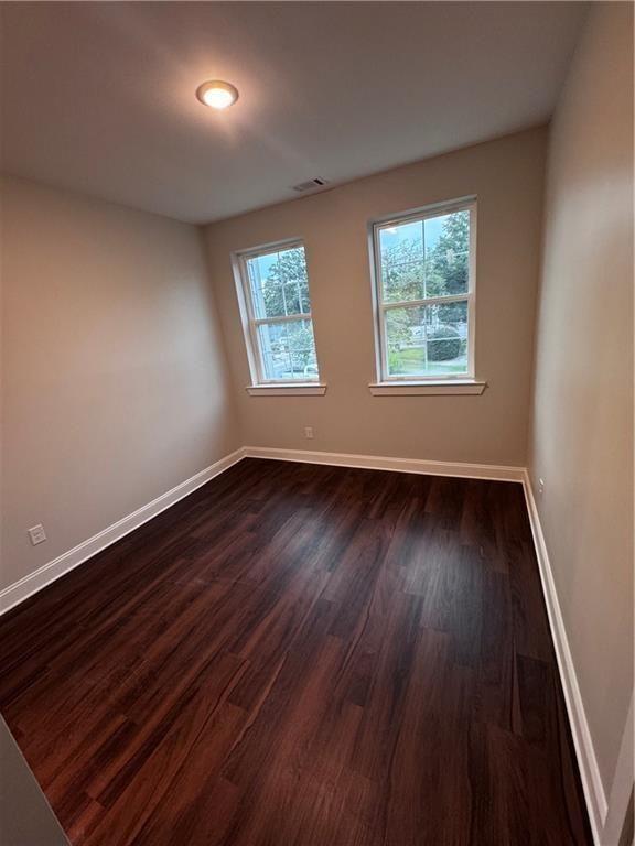 1777 Temple Avenue, Unit N Atlanta, GA 30337 - Photo 21 of 22 an empty room with wooden floor and windows