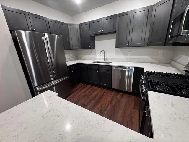 a kitchen with wooden floors and wooden cabinets