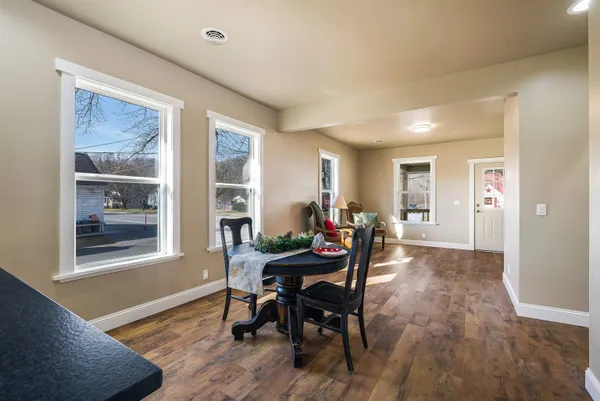 a view of a dining room with furniture and a window