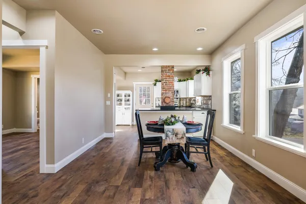 a dining room with furniture and wooden floor