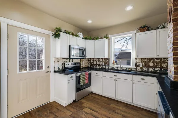 a kitchen with granite countertop a sink and cabinets