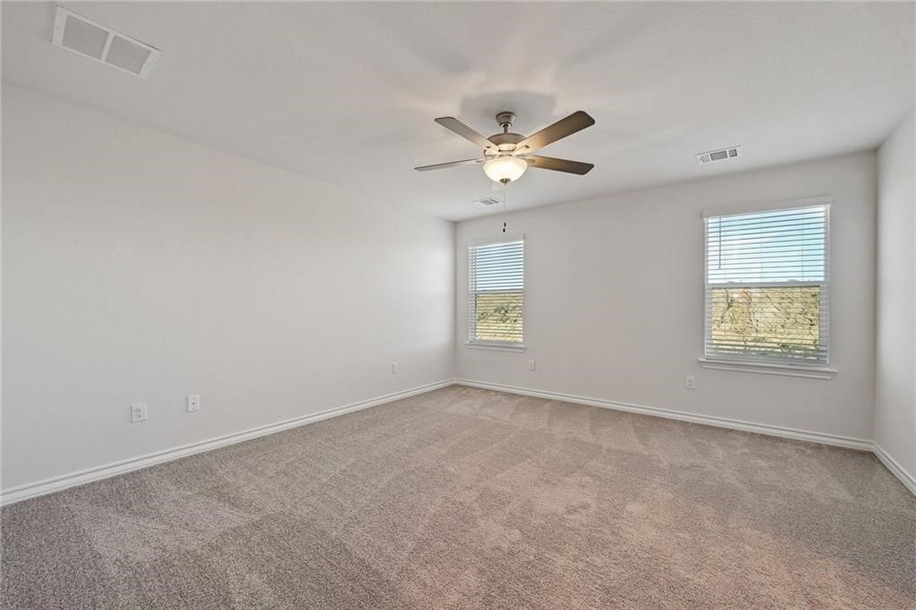 806 Pepperbark Loop Buda, TX 78610 - Photo 19 of 39 an empty room with windows and fan