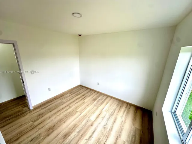 a view of an empty room and wooden floor