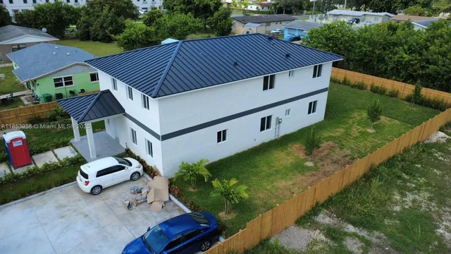 a view of backyard with wooden fence