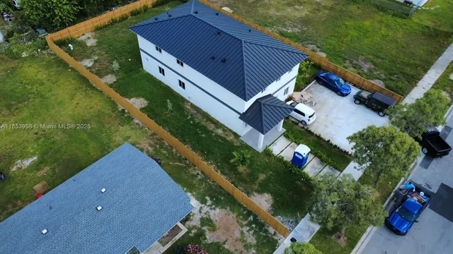 a large kitchen with stainless steel appliances a large counter top a sink a stove a refrigerator and cabinets