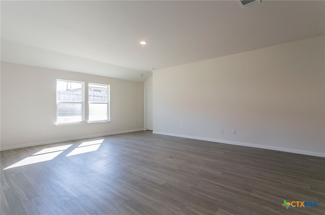 3817 Poteet Court Temple, TX 76504 - Photo 3 of 13 a view of an empty room with wooden floor and a window