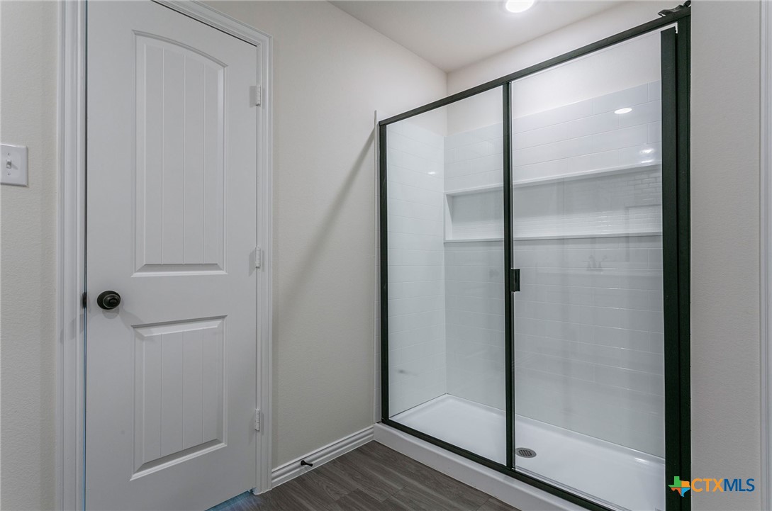 3817 Poteet Court Temple, TX 76504 - Photo 8 of 13 a bathroom with a glass shower door