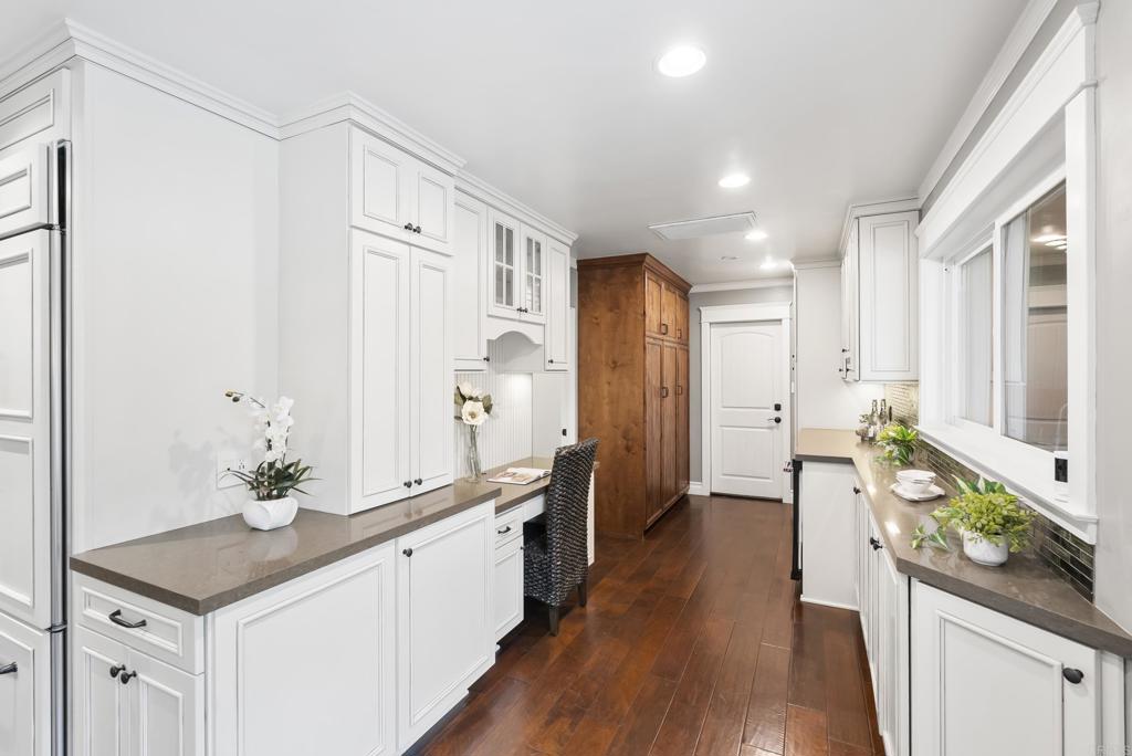 4847 Vita Road La Mesa, CA 91941 - Photo 22 of 73 a large white kitchen with a sink and wooden floor