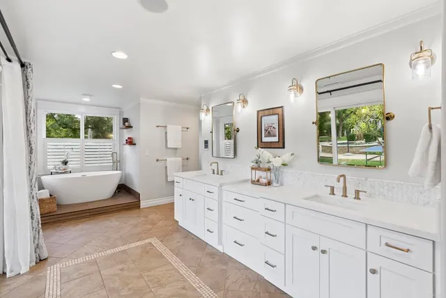 a bathroom with a toilet a sink a glass door shower and mirror