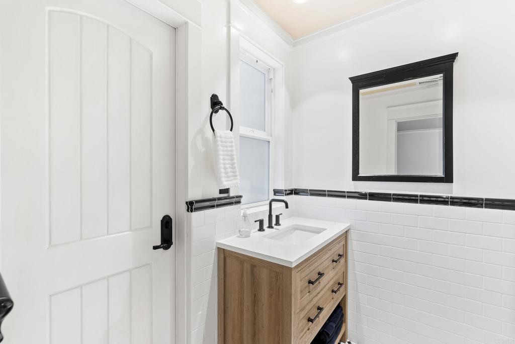 4847 Vita Road La Mesa, CA 91941 - Photo 37 of 73 a bathroom with a double vanity sink and a mirror