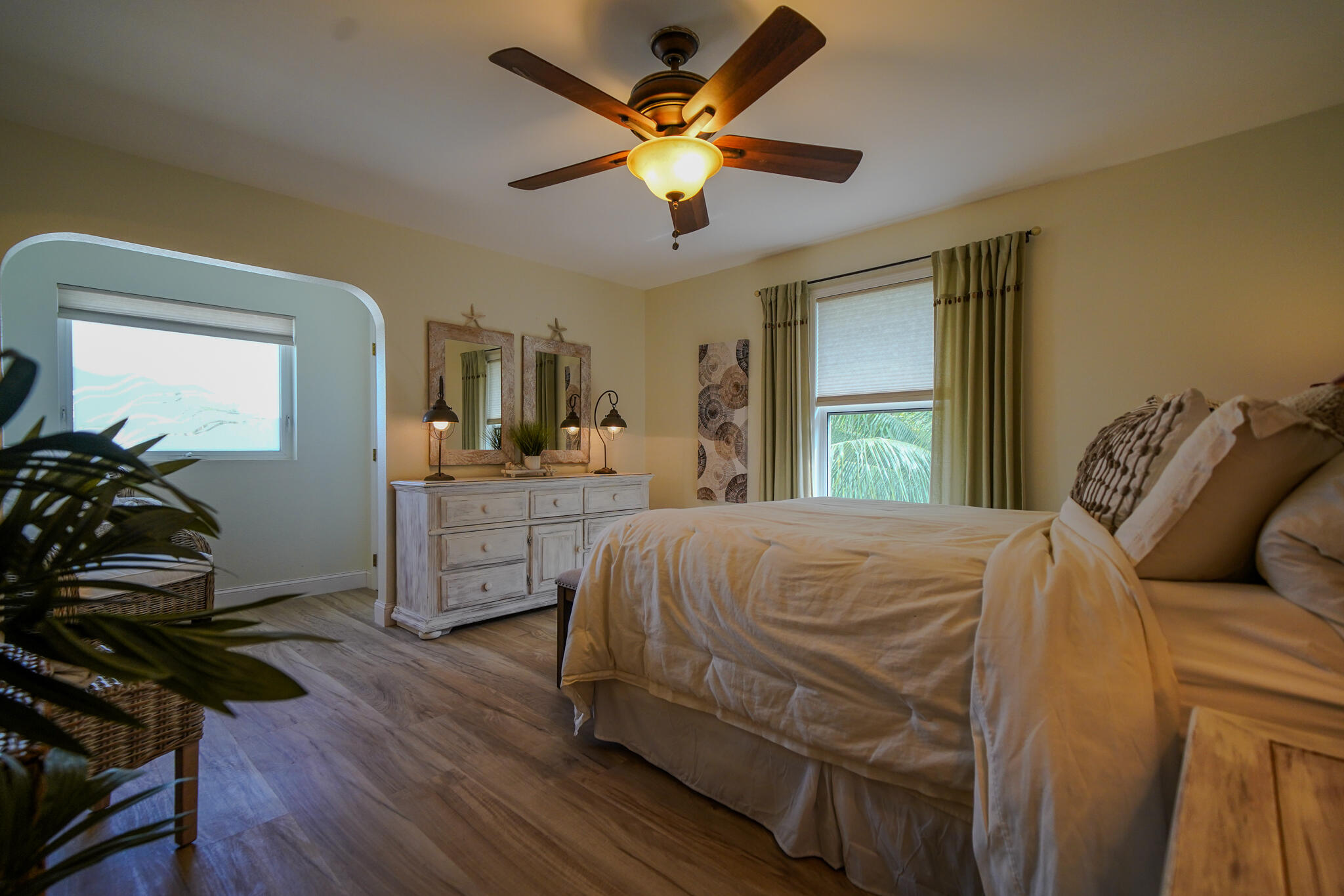 21 Corrine Place Key Largo, FL 33037 - Photo 17 of 46 a bedroom with a bed and a large mirror with wooden floor