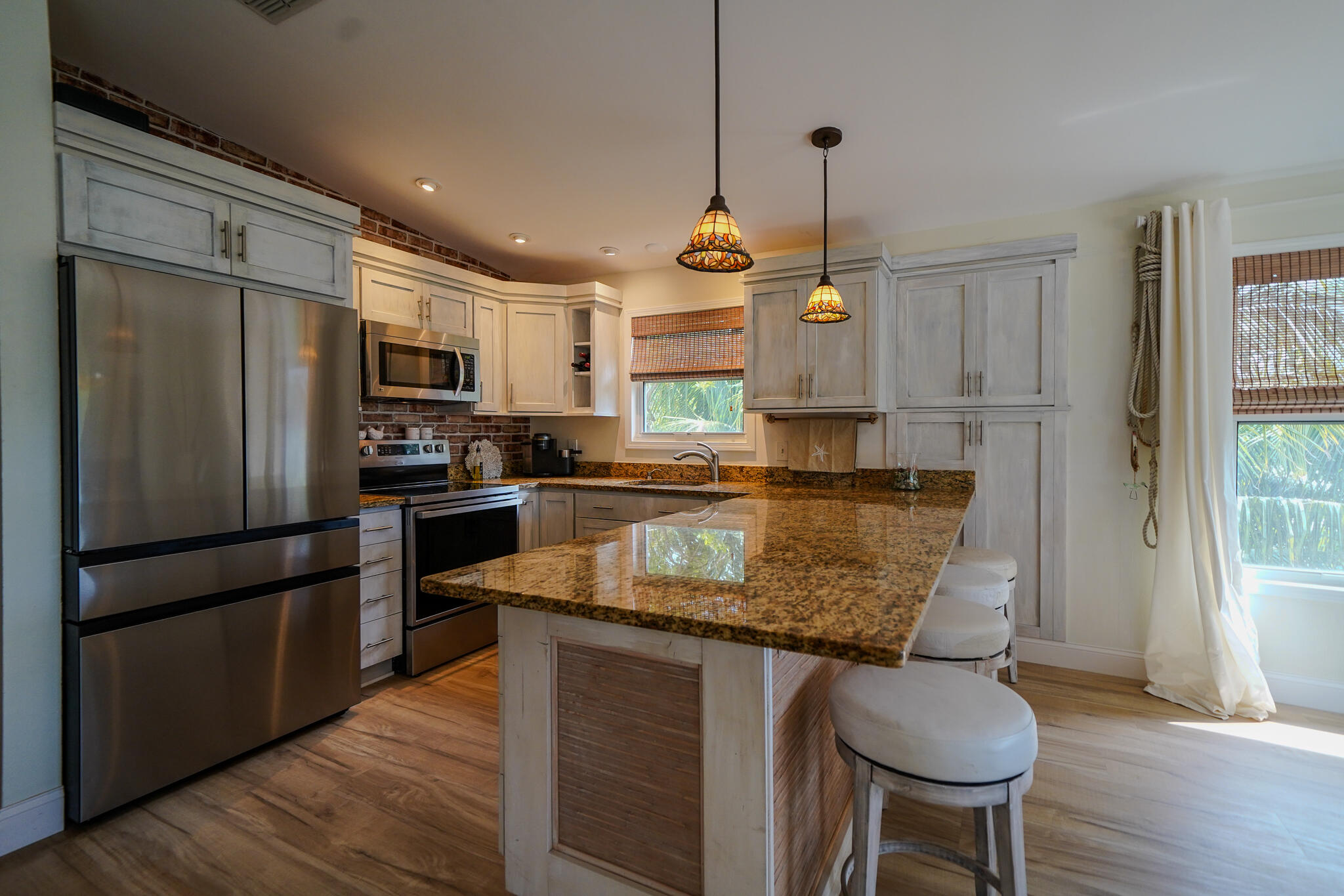 21 Corrine Place Key Largo, FL 33037 - Photo 6 of 46 a kitchen with stainless steel appliances granite countertop a sink refrigerator and microwave