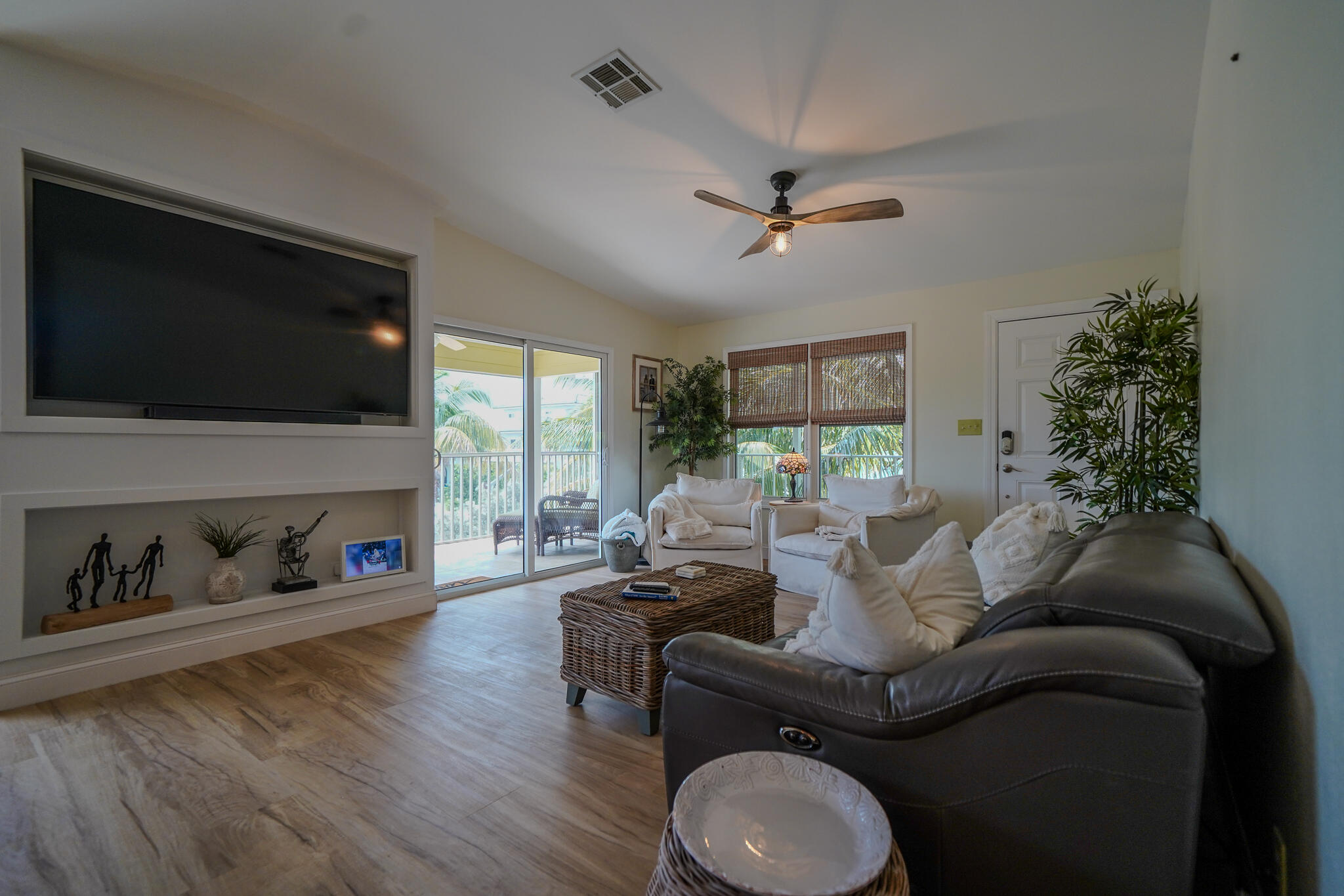 21 Corrine Place Key Largo, FL 33037 - Photo 8 of 46 a living room with furniture a flat screen tv and a fireplace