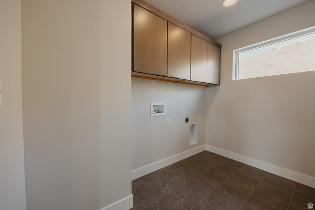 5910 Canyon Rim Road, Unit 619 Lehi, UT 84048 - Photo 47 of 52 Laundry space featuring upper cabinetry, a mounted clothes rod, a rectangular window, and neutral-toned floor tiling