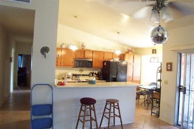 7220 North Artesiano Road Tucson, AZ 85743 - Photo 2 of 8 a kitchen with stainless steel appliances a table and chairs in it