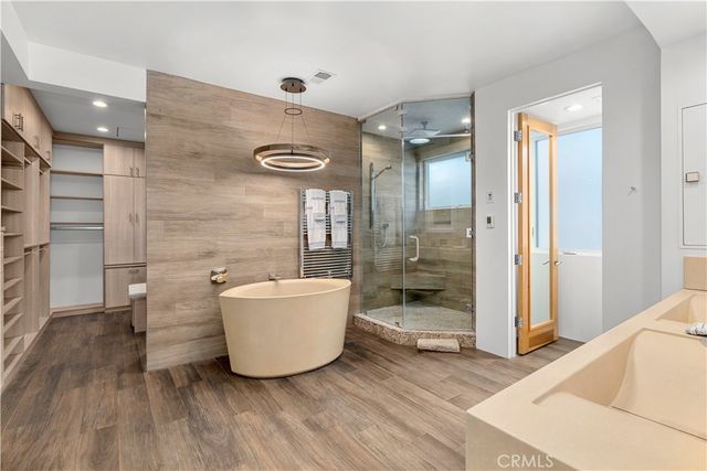 a view of a patio with couches table and chairs and potted plants