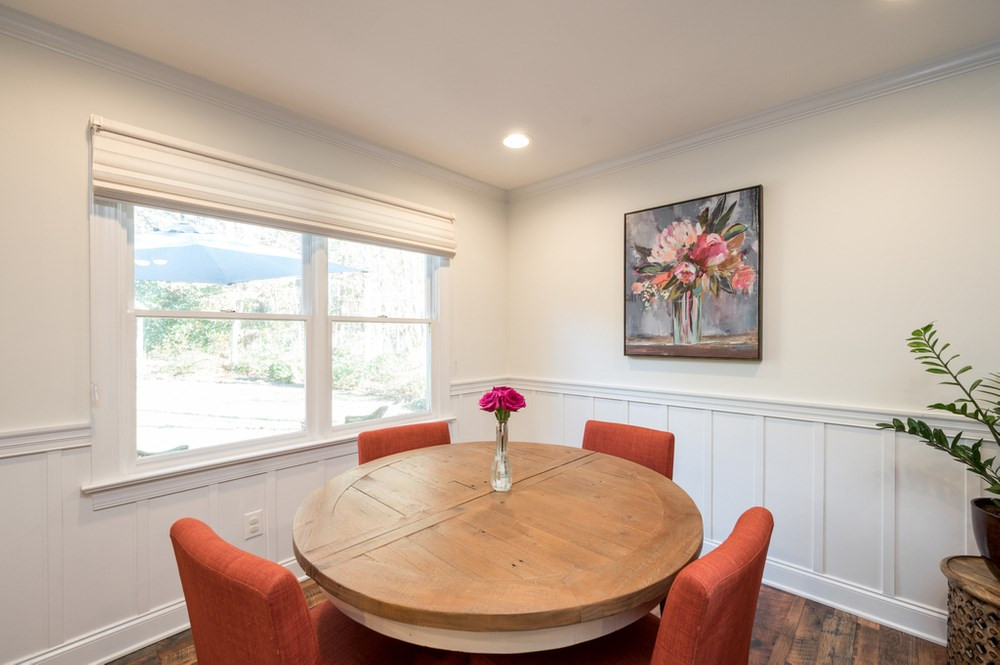 4709 Randolph Court Raleigh, NC 27606 - Photo 8 of 27 The breakfast nook / dining area off the kitchen features board and batten trim detail and custom roman shades.