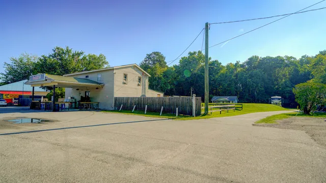 a swimming pool with yard in front of it