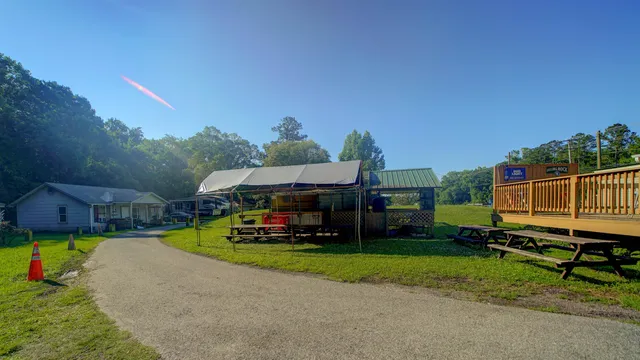 a car parked in front of a house with a yard