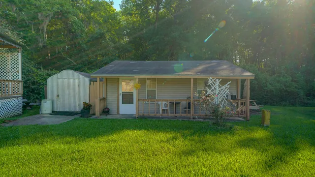 a view of a house with a yard and sitting area