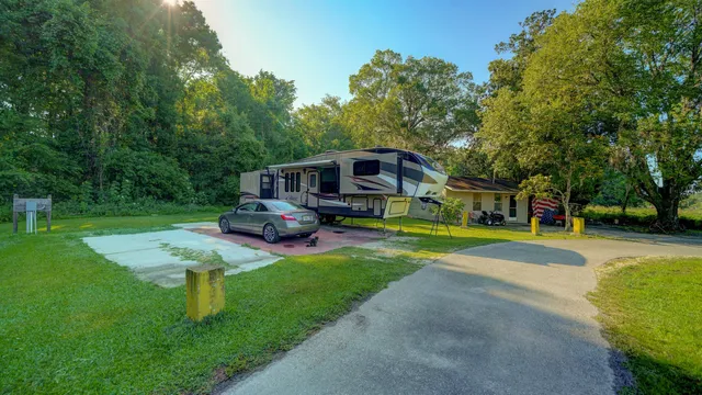 a view of patio with table and chairs under an umbrella
