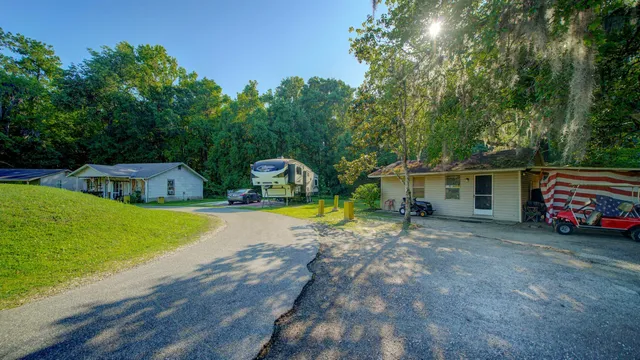 a view of a house with swimming pool and sitting area