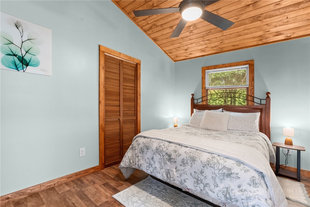 139 Golden Rod Loop Newland, NC 28657 - Photo 16 of 39 a bedroom with a bed and a potted plant