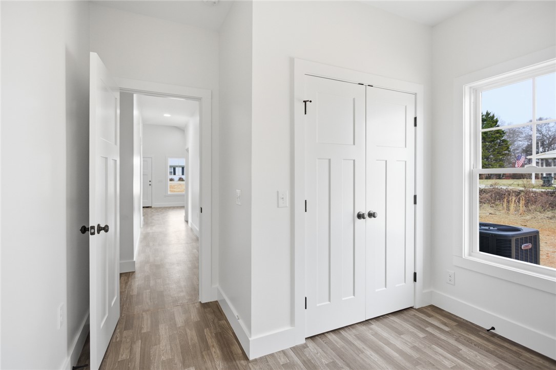 115 Riley Street Westminster, SC 29693 - Photo 21 of 46 This bright hallway showcases durable flooring, offering a seamless flow to the inviting spaces beyond.
